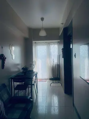 a living room with a table and a window at StayInMyCondo - 30th Condo in Pasay with Pool near Airport MOA,CCP & PICC In Pasay in Manila