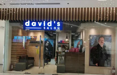 a woman in the window of a clothing store at Apad@graceresidences nr BGC in Manila