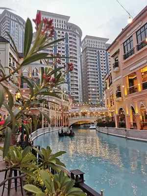 a canal in the middle of a city with tall buildings at Apad@graceresidences nr BGC in Manila