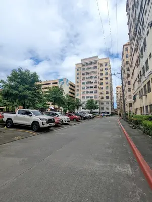 a city street with cars parked on the side of the road at Budget 1BR Loft Apartment in Cainta Cambridge Village in Cainta