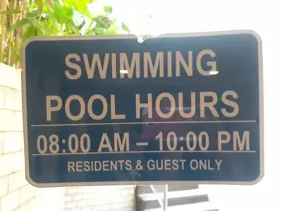 a blue sign that reads swimming poolhuts posted at ZG-150Newport in Manila