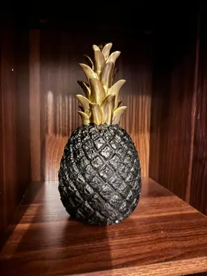 a pineapple sitting on top of a wooden table at Beautiful 1bed condo Nr Airport, MOA, Makati, Bay in Manila