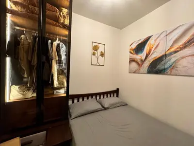 a bedroom with a bed and a closet at Beautiful 1bed condo Nr Airport, MOA, Makati, Bay in Manila