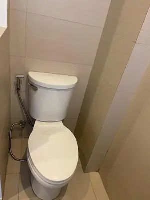 a bathroom with a white toilet in a room at Wow Budget Hotel Cubao in Manila