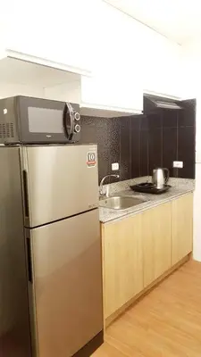 a kitchen with a stainless steel refrigerator and a sink at The Linear Makati Condo Stunning Hotel Type Interior in Manila