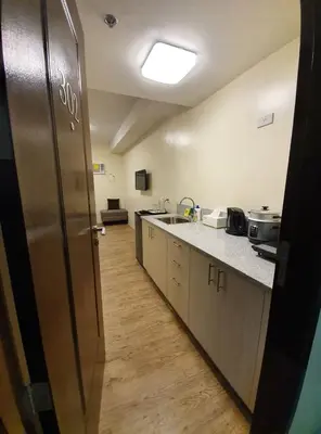 a kitchen with a stainless steel refrigerator in a room at Lilian Stanford Suites 2 South Forbes Inchican Silang Cavite in Silang