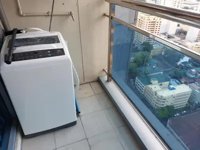 a washing machine in a room with a window at MANILA BAY FRONT DELUX Pearl of the orient in Manila