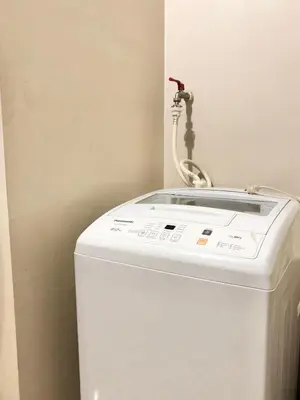 a white refrigerator with a faucet on top of it at Hotel Type Condo Near NAIA Manila Airport in Manila