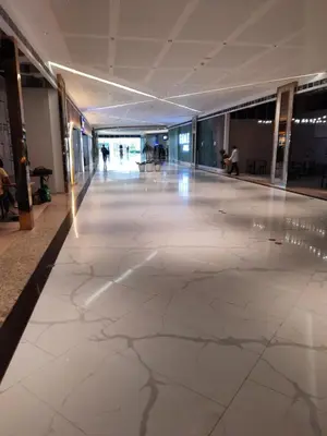 a large lobby with a marble floor and people in a building at SMDC FAME Residences David 's place in Manila