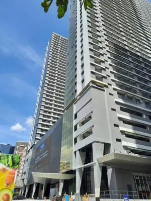 a tall building with a billboard on the side of it at SMDC FAME Residences David 's place in Manila