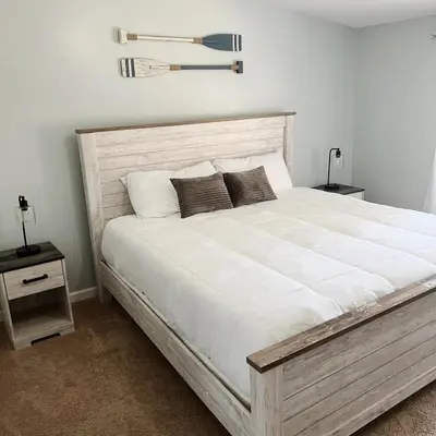 a bedroom with a large white bed with two night stands at Homie Sweetie in Morong
