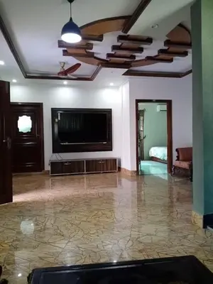 a living room with a flat screen tv and a couch at Homie Sweetie in Morong