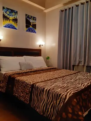 a bedroom with a bed with a zebra print blanket at Sarasota Residential Resort cluster 4 Unit 6B and 6C by Manny Newport Blvd, across NAIA T3 & near Resorts World Manila, Pasay City in Manila