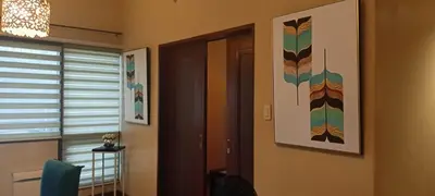 a room with a door and a picture on the wall at 18F staycation in Manila