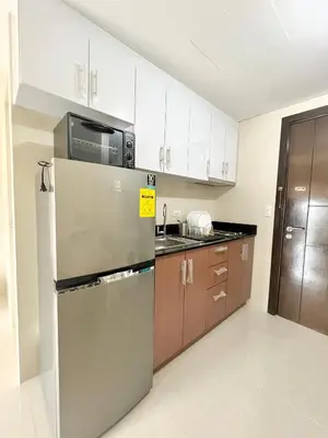 a kitchen with a refrigerator and a microwave at Luxury Hotel Type Condo Near NAIA Manila Airport in Manila