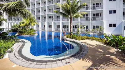 a swimming pool in front of a large building at Shore Residences Mall of Asia Pool View 200mbps Free Wi-Fi in Manila