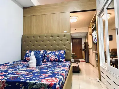 a bedroom with a bed with a large headboard at Sea Residences - Property Val Alano 0995-448-8872 in Manila