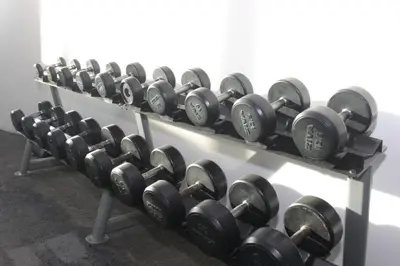 a row of dumbbells on a shelf in a gym at A2J Luxury 1BR BGC Balcony Suite Near BurgosCircle in Manila