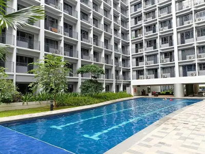 a large apartment building with a large swimming pool at Home away from Home in Manila