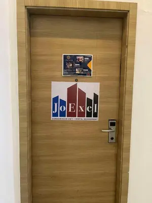 a wooden door with a sign on it at Spacious One Bedroom 20888 in Manila