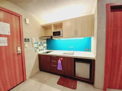 a small kitchen with a sink and a microwave at Spacious One Bedroom 20888 in Manila