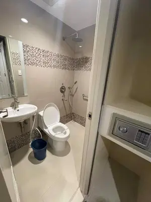 a small bathroom with a toilet and a sink at Hotel Sogo Edsa Cubao in Manila