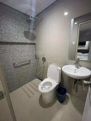 a bathroom with a toilet and a sink at Hotel Sogo Edsa Cubao in Manila