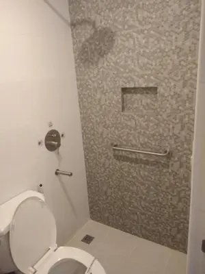 a bathroom with a toilet and a shower stall at Hotel Sogo Edsa Cubao in Manila
