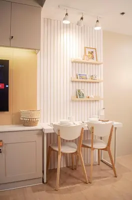 a dining room with a white table and chairs at Cozy and Classy Studio Across Airport Terminal 3 in Manila