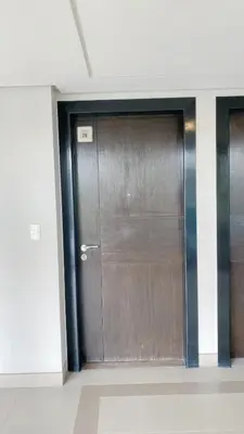 a large wooden door in a building with at Cozy and Classy Studio Across Airport Terminal 3 in Manila