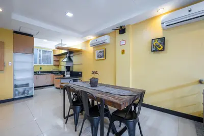 a kitchen with a wooden table and chairs at Casa Heradurra Uno/Dos in Manila