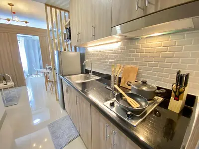 a kitchen with a stove with pots and pans on it at Will’s Place @ Shore2 Residences Mall of Asia in Manila