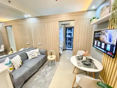 a living room with a couch and a table at Will’s Place @ Shore2 Residences Mall of Asia in Manila