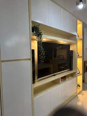 a living room with a tv on a wall at Mel and Rose Place in S Residences Tower 1 MOA in Manila
