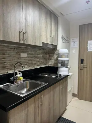 a kitchen with a sink and a counter top at Mel and Rose Place in S Residences Tower 1 MOA in Manila