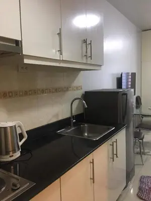 a kitchen with a sink and a counter top at Sea Residences Prestige in Manila