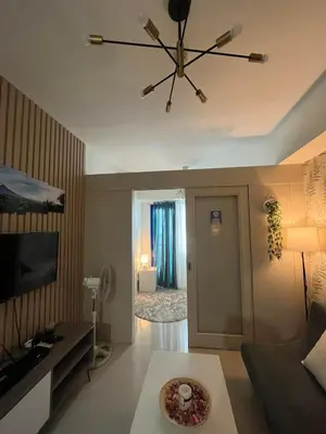 a living room with a ceiling fan and a living room at Easy Stay Sea Residences in Manila