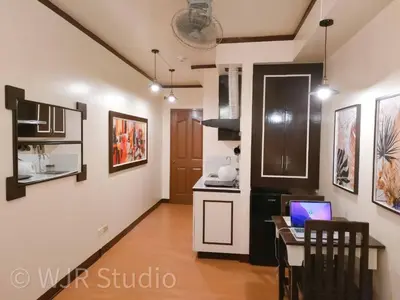 a kitchen with a desk and a laptop on a table at Queen Bed Deluxe- Contemporary Style in Manila