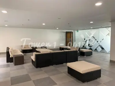 a lobby with couches and tables and a sign at SMDC S Residences MiCasa, MOA area in Manila