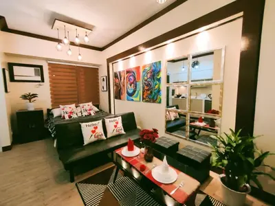 a living room with a couch and a table at Choco Condotel- Anuva Prime 2 Cozy & Stylish Place in the Metro in Manila
