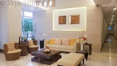 a living room with a couch and a table at Choco Condotel- Anuva Prime 2 Cozy & Stylish Place in the Metro in Manila