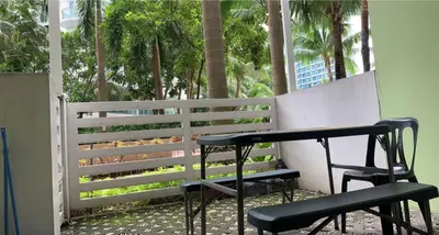 a bench and a table and two chairs on a porch at Azure Urban Resort in Manila