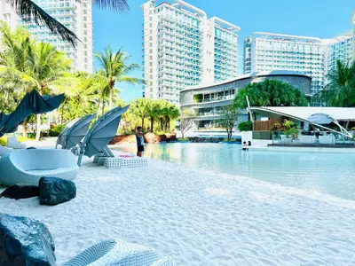 a resort with a pool of water and some buildings at Scr Summer Vibe Netflix Balcony in Manila