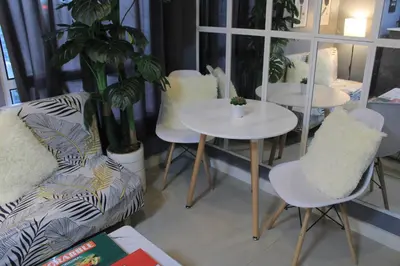 a room with two tables and a couch and chairs at A2J BGC Luxury 2BR Loft Near Burgos Circle, Malls in Manila