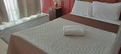 a bed with a white pillow sitting on top of it at AZURE A6 beachpool with Balcony Wifi near mall airport in Manila