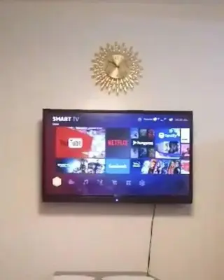 a flat screen tv hanging on a wall at MOA Shore 2 1BR with Balcony WiFi Netflix Pool 4Pax in Manila