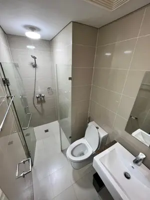 a bathroom with a toilet and a shower and a sink at Studio at Newport World Airport Area Prime Location in Manila
