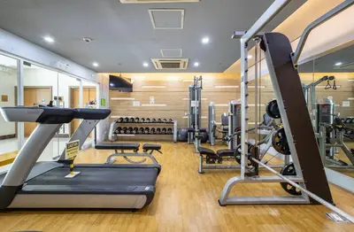 a gym with treadmills and elliptical machines at Studio at Newport World Airport Area Prime Location in Manila