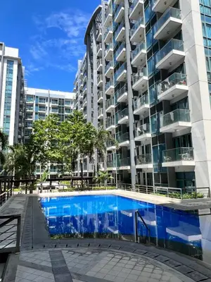 a swimming pool in front of a building at Studio at Newport World Airport Area Prime Location in Manila