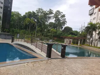 a bridge over a swimming pool in a building at Affordable Tagaytay Monteluce 2 BR with Pool G28 in Silang